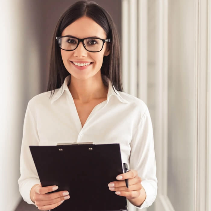 Therapist taking notes while young male patient talks during session